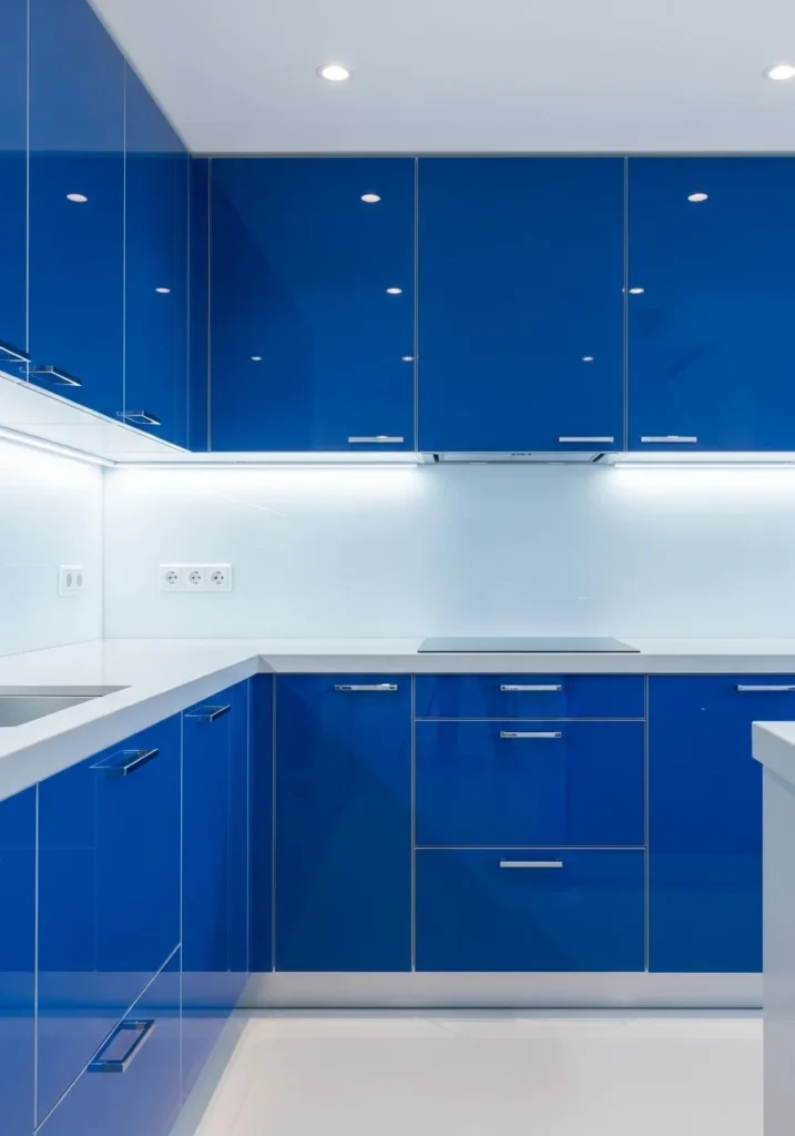 High-gloss blue kitchen cabinets with sleek contemporary finishes.