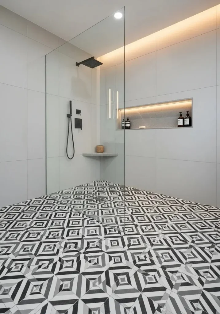 Shower remodel featuring eye-catching patterned floor tiles for a bold statement